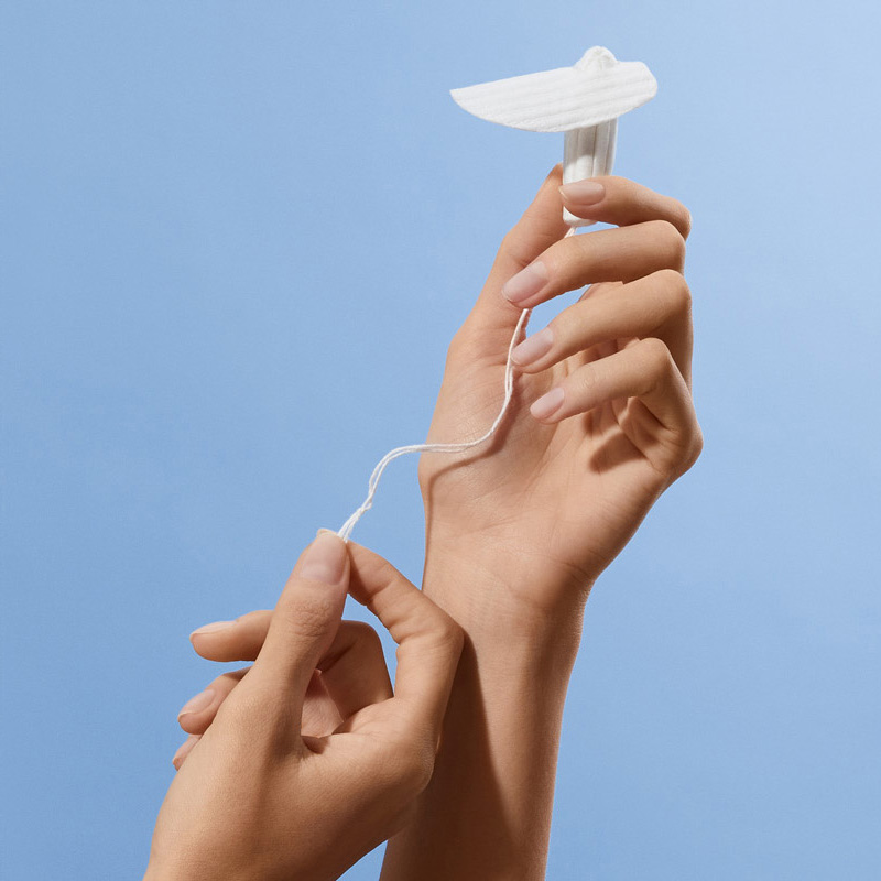 A Calla Lily Clinical Care device is held up against a light blue background
