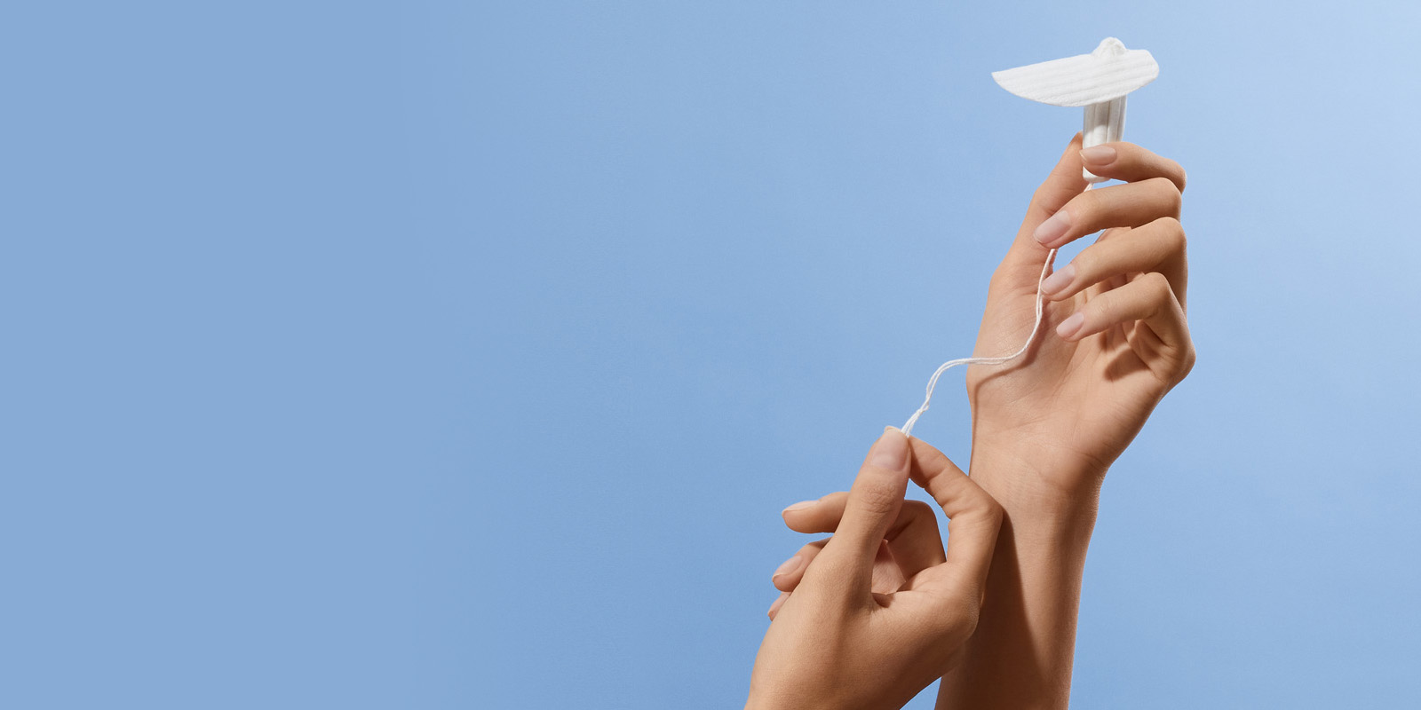 A Calla Lily Clinical Care device is held up against a light blue background